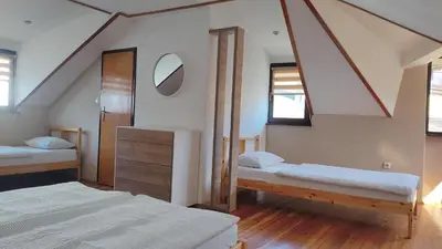 a bedroom with two beds and a mirror at NETWORK apartment in Jajce