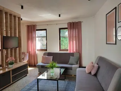 a living room with a couch and a tv at NETWORK apartment in Jajce