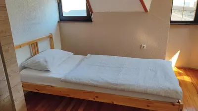 a bed with white sheets and pillows in a room at NETWORK apartment in Jajce