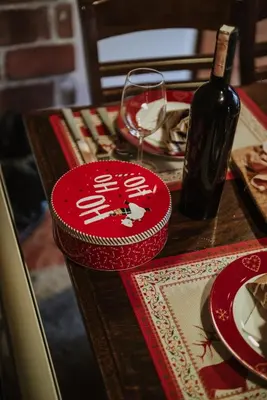 a table with a bottle of wine and a glass at Villa Ela in Kupres