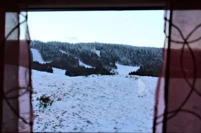 a view of a snow covered field from a window at Villa Ela in Kupres