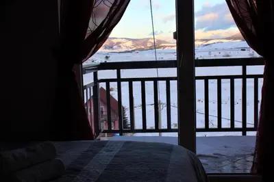 a bedroom with a view of a snow covered mountain at Villa Ela in Kupres