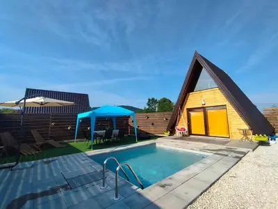a house with a swimming pool next to a building at Villa Dream House Bihac in Bihać