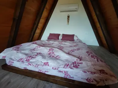 a bedroom with a bed with purple flowers on it at Villa Dream House Bihac in Bihać