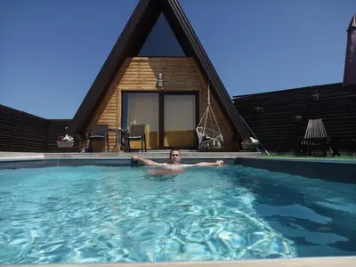 a man in a swimming pool in a house at Villa Dream House Bihac in Bihać