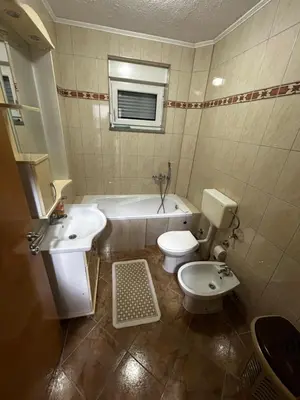 a bathroom with a tub and a toilet and a sink at Apartman Bošnjak Ramsko jezero in Podbor