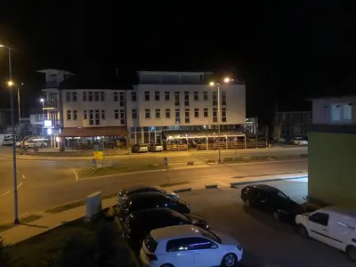 a group of cars parked in a parking lot at night at Studio Apartman Centar in Zenica