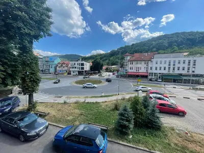 a town with cars parked in a parking lot at Studio Apartman Centar in Zenica