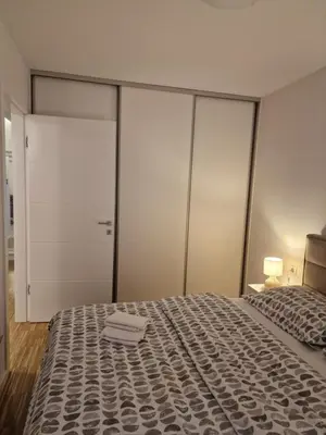 a bedroom with a large bed and a closet at Nika in Banja Luka
