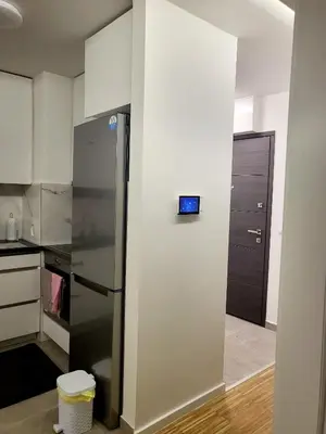 a kitchen with a refrigerator with a clock on the wall at Nika in Banja Luka