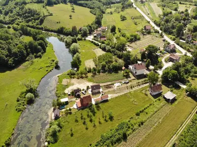 an aerial view of a village next to a river at Smjestaj na selu Stankovic - Pliva in Šipovo