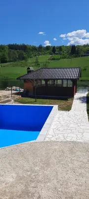 two pictures of a house with a roof at Smjestaj na selu Stankovic - Pliva in Šipovo
