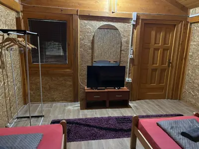 a living room with a tv and a mirror at Flora&Fauna in Bihać