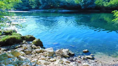 a body of water with rocks on the shore at Flora&Fauna in Bihać