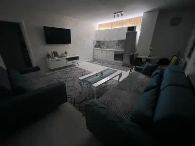 a living room with a couch and a table at Sunset Delux Apartment in Visoko