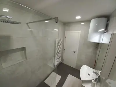 a bathroom with a shower and a toilet and a sink at Sunset Delux Apartment in Visoko