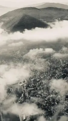 an aerial view of a city in the clouds at Sunset Delux Apartment in Visoko