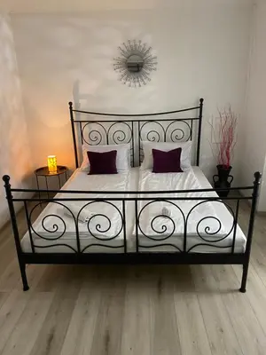 a black and white bed with two pillows on it at Royal Residence in Visoko