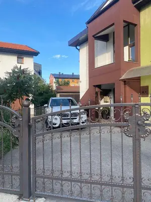 a gate in front of a house with a car at Royal Residence in Visoko