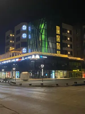 a building with a lit up facade at night at Royal Residence in Visoko