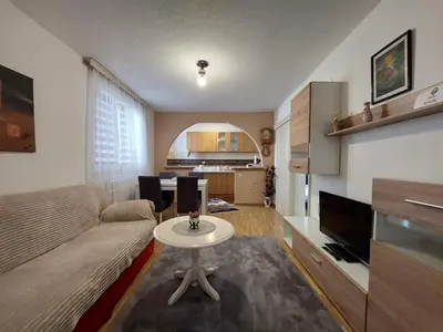 a living room with a couch and a table at Apartment EM in Tuzla