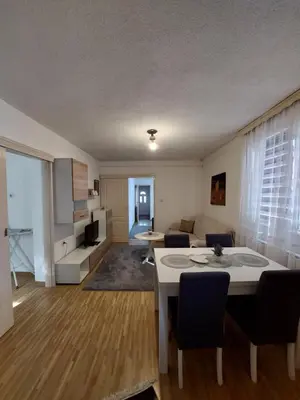 a living room with a couch and a table in a room at Apartment EM in Tuzla