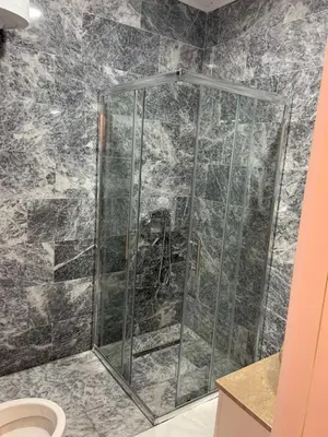 a shower with a glass door in a bathroom at Apartment Aria in Travnik
