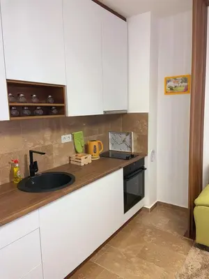a kitchen with white cabinets and a sink at Apartment Aria in Travnik