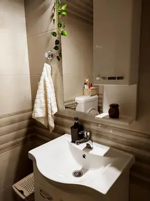 a bathroom with a white sink and a mirror at Apartman Sunshine in Doboj