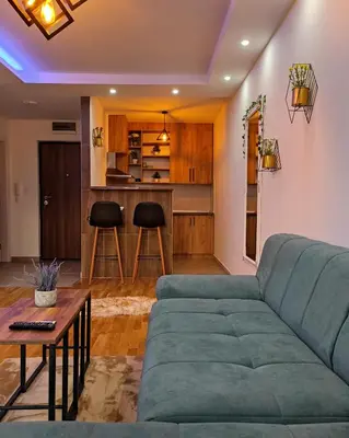 a living room with a couch and a table at Apartman Sunshine in Doboj