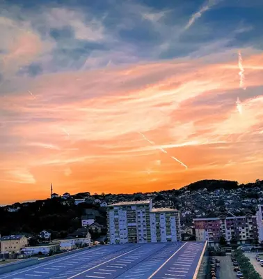 a view of a city skyline at sunset at Apartman Sunshine in Doboj
