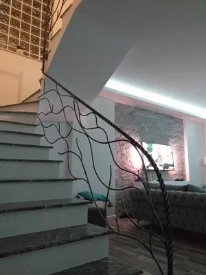 a metal sculpture on the stairs in a living room at Riverside Plaza in Bihać