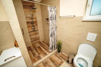 a bathroom with a shower and a toilet at Riverside Plaza in Bihać
