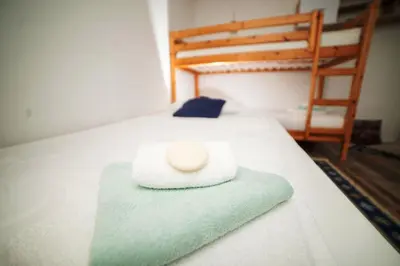 a white towel sitting on top of a bed at Riverside Plaza in Bihać