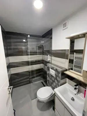 a bathroom with a toilet and a shower and a sink at Motel 