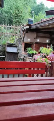 a red bench sitting in front of a garden at Motel 