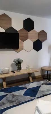 a living room with a wooden table and a rug at Motel 