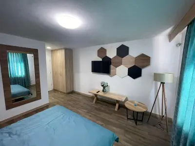 a room with a bed and a table and a mirror at Motel 