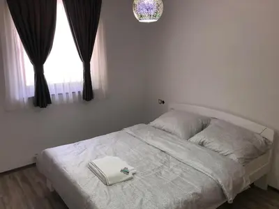 a white bed in a bedroom with a window at Motel 