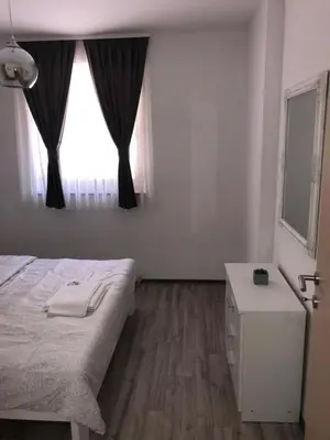 a bedroom with a bed and a dresser and a window at Motel 