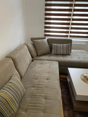 a living room with a couch and a table at New Apartment in the City in Visoko