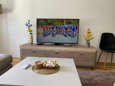 a living room with a flat screen tv on a table at New Apartment in the City in Visoko