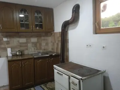 a kitchen with a sink and a pipe on the wall at Etno selo Visoko Apartmani in Visoko