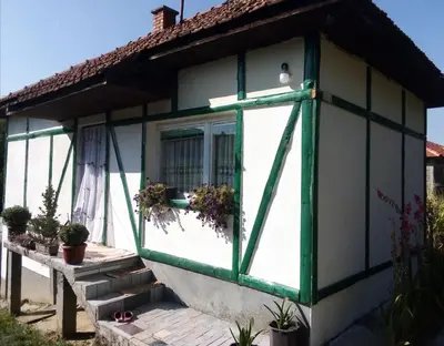 a small house with a green and white window at Etno selo Visoko Apartmani in Visoko