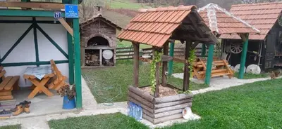 a model of a house with a grill and a building at Etno selo Visoko Apartmani in Visoko