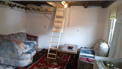 a living room with a ladder and a couch at Etno selo Visoko Apartmani in Visoko