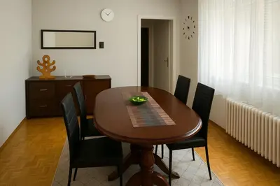 a dining room table with black chairs and a dining room at Apartman Centar Banja Luka in Banja Luka