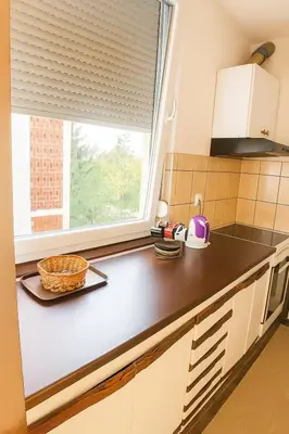 a kitchen with a counter top and a window at Apartman Centar Banja Luka in Banja Luka