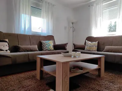 a living room with a couch and a coffee table at Apartman 