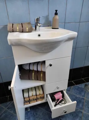 a bathroom vanity with a sink and towels at Apartman 